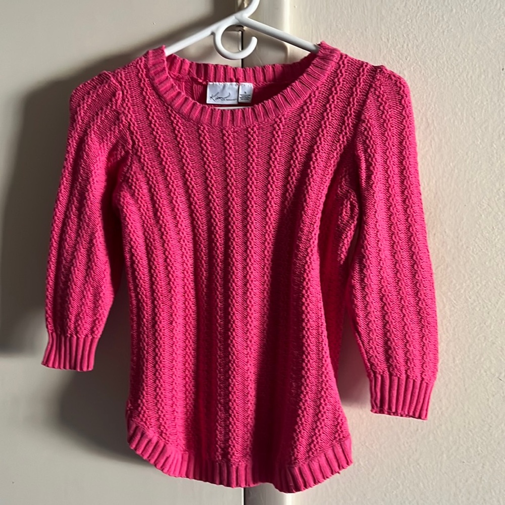 Kim Rogers pretty in pink sweater.